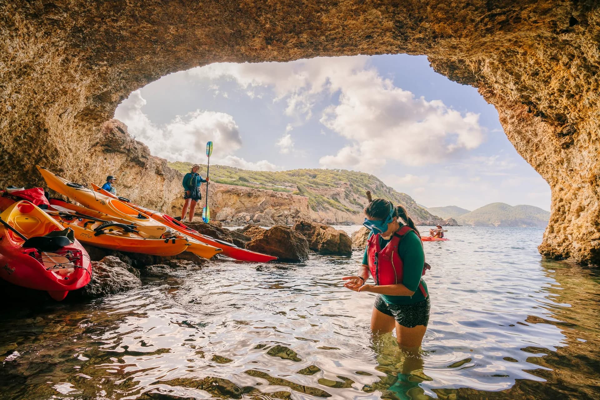 Group of kayaks in a turquoise cove in Ibiza