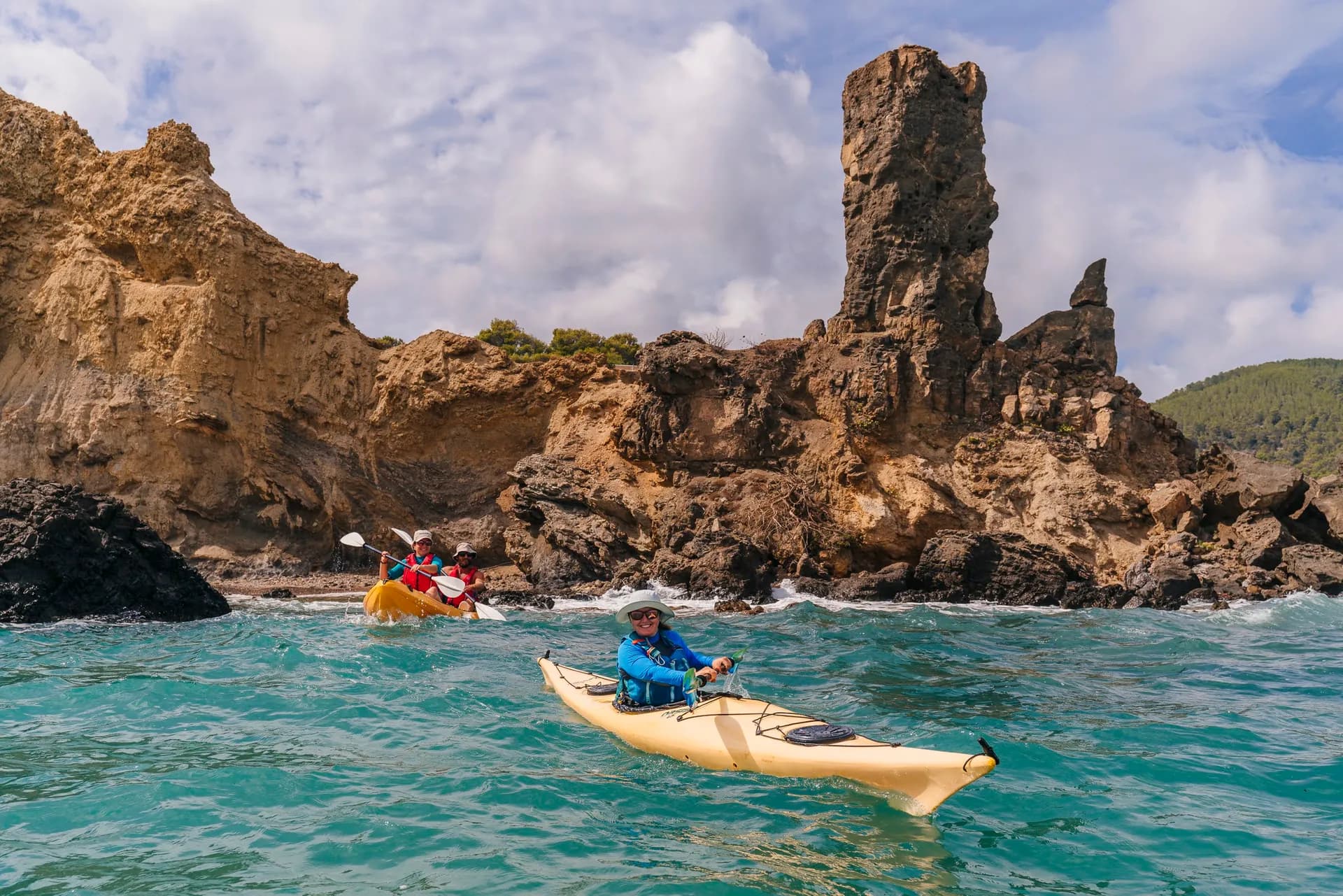 Kayaking past dramatic rock formations and cliffs