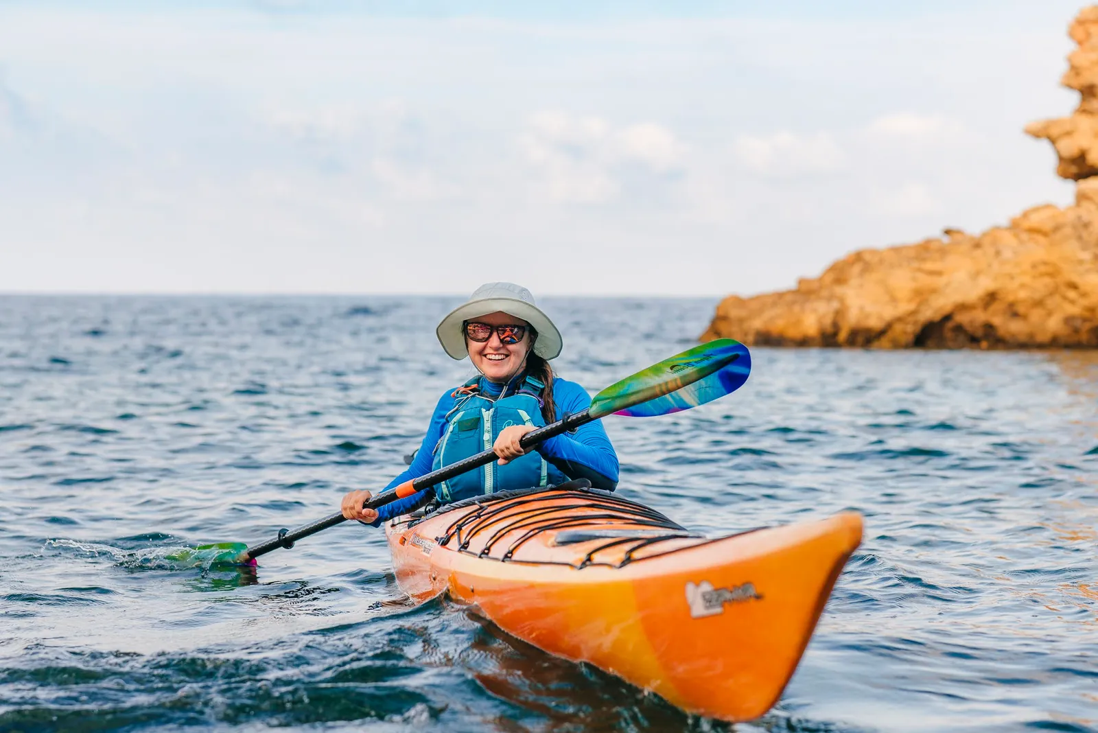 Kayaker on calm water at sunset in Ibiza